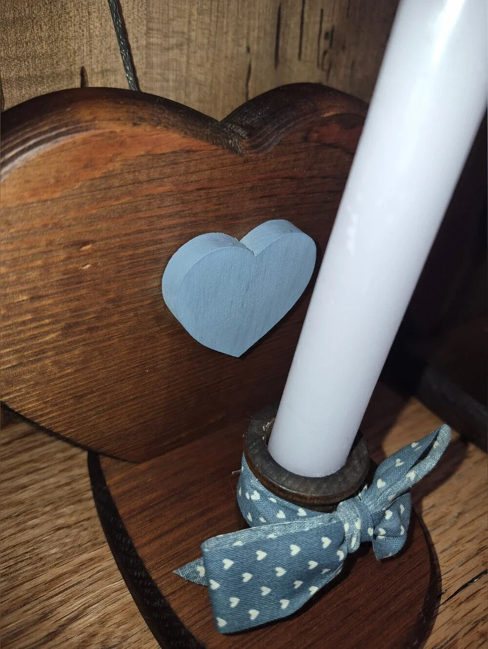 Set of handmade rustic wooden heart candle holders featuring blue heart accents